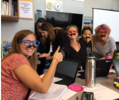 second grade staff wearing fake mustaches