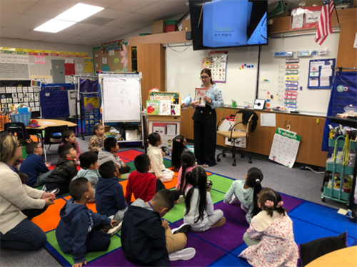 Mrs. Ruiz teaches letter sounds to her kindergarten readers